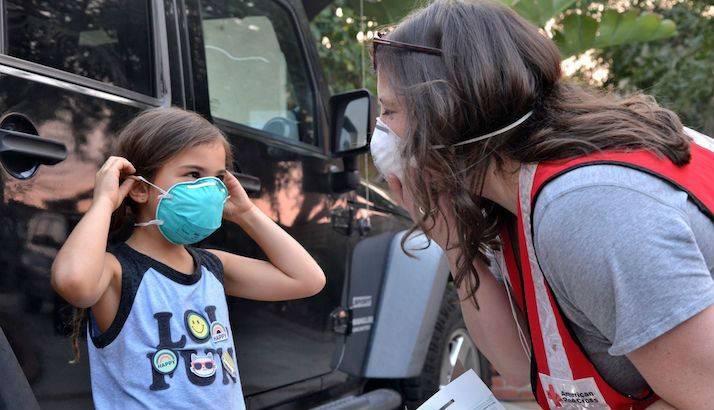 A Red Cross volunteer provides filter masks to help protect Ventura County residents from wildfire smoke.