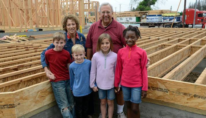 Candace and Rick Hall join their four grandchildren at the site where their home used to stand before the 2017 wildfires.