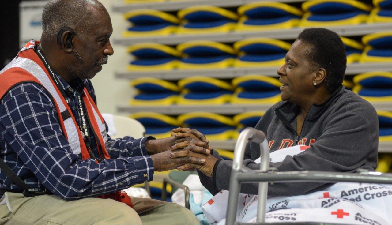 A Red Cross volunteer talks with a person affected by Hurricane Barry