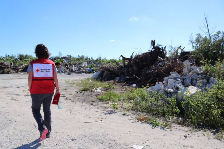 Field Representative Amy Bruins walks among debris left over from Hurricane Dorian in Sweetings Cay.