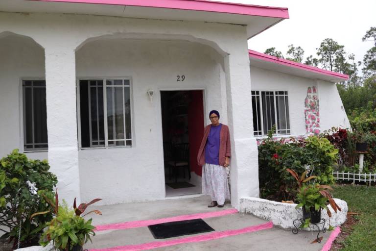 Constance Plakaris standing outside of her home.