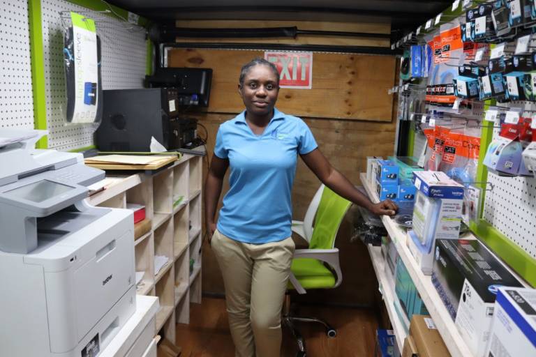 Johnell Curry-Russell standing inside of her computer repair shop in Abaco, Bahamas.
