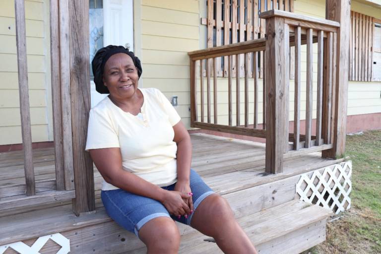 Mary Newbold sitting on her front porch.