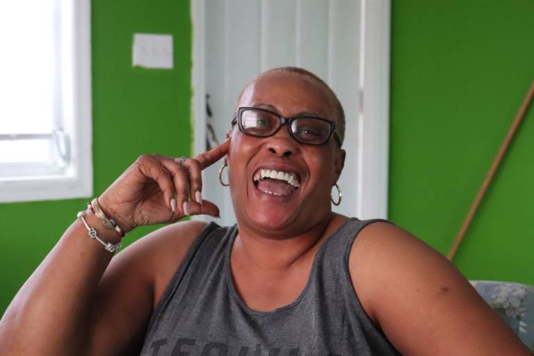 Sharon Octavien smiling in her home.