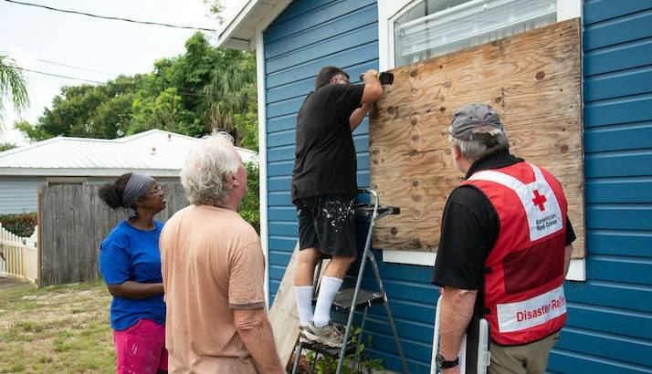 Jackie and Bruce Foster, board up windows in advance of Hurricane Dorian.