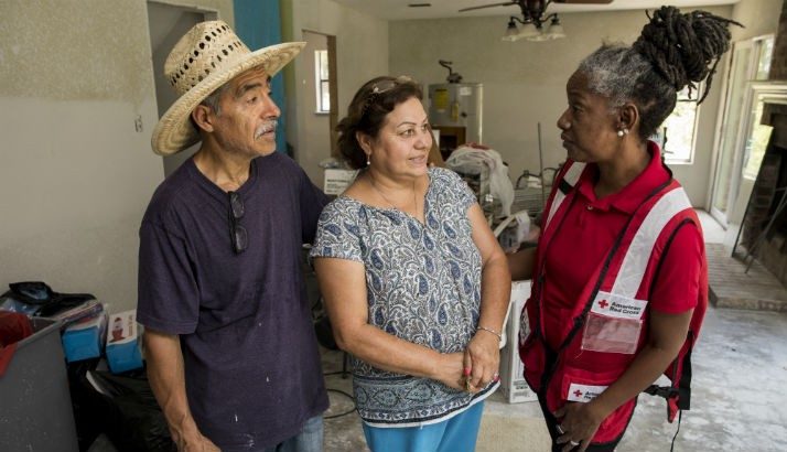 A Red Cross volunteer visits with a couple affected by Hurricane Harvey