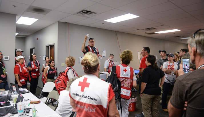 Julian Delgado with Health Services explains to volunteers the process of properly administering Narcan to clients who may need it in shelters.