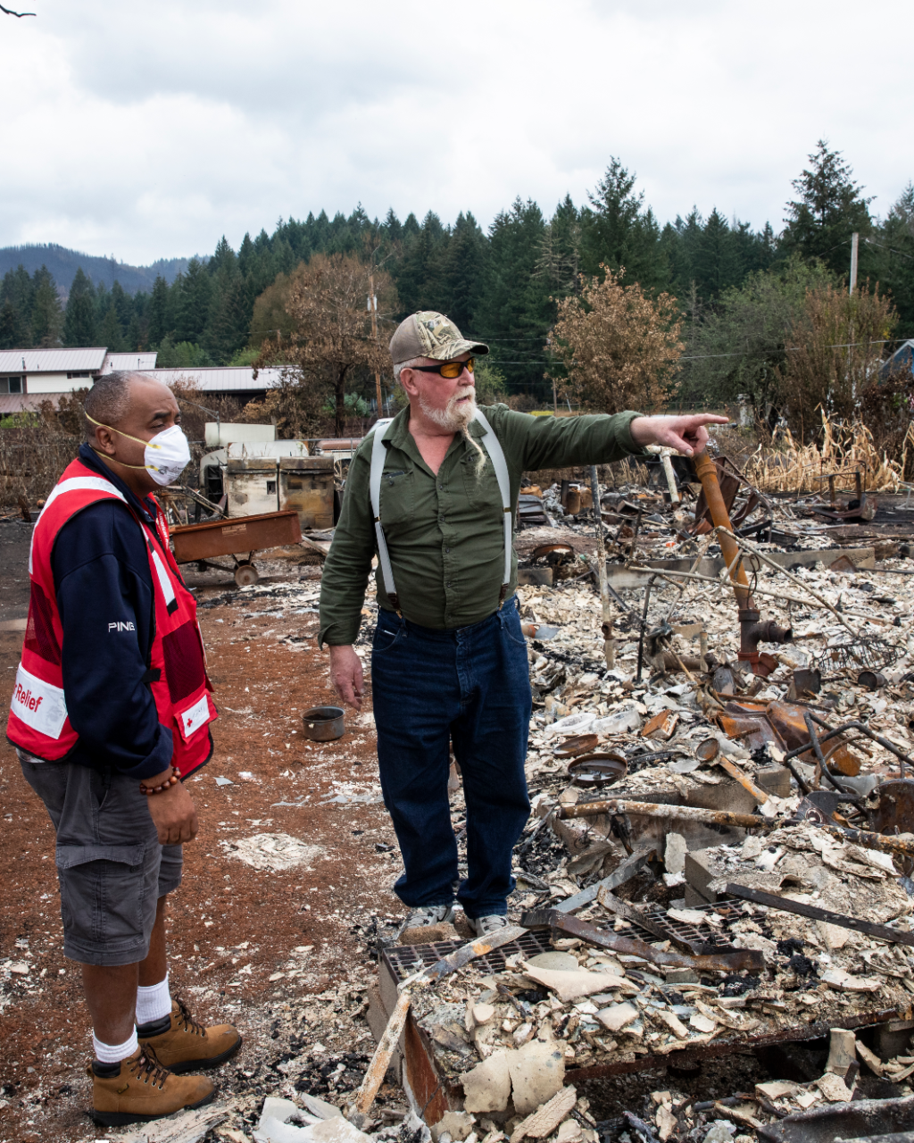 Red Cross volunteer surveying the damage caused by a disaster