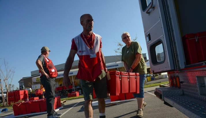 American Red Cross workers Terri Mehling and Mark Edwards load a Red Cross feeding vehicle with hot foods.