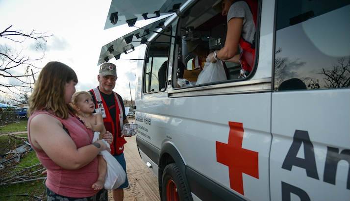 Malaisha and her two-year-old daughter Dellakate were delighted to receive hot meals from American Red Cross feeding vehicle.