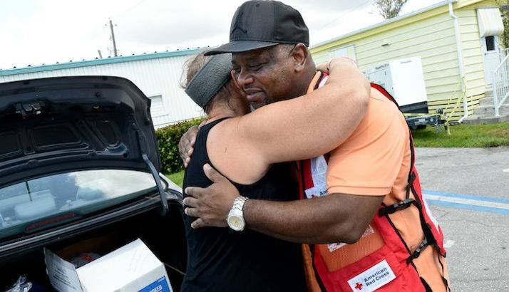 Red Cross Volunteer Robert receives a hug from Sabrina, a resident from Naples, Florida.