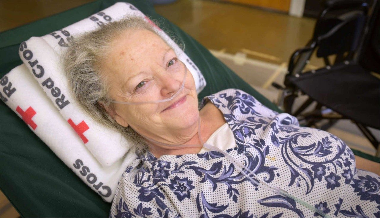 A woman receiving medical attention at a shelter.