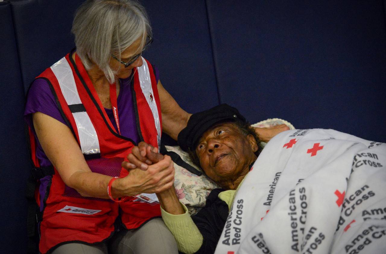 September 15, 2018. Washington High School Red Cross operated shelter. Washington, North Carolina.Shelter resident, Elizabeth is 82 years old and still enjoys working one day per week. She evacuated her home on September 12, 2018 and has not been able to return to assess the extent of damage by Hurricane Florence. Impassable roads and closed bridges have had no impact on her bright spirit. She speaks highly of her favorite Red Cross volunteer, “I am grateful of Ms. Elaine’s help. She has been taking care of me.”Photo by Daniel Cima/American Red Cross
