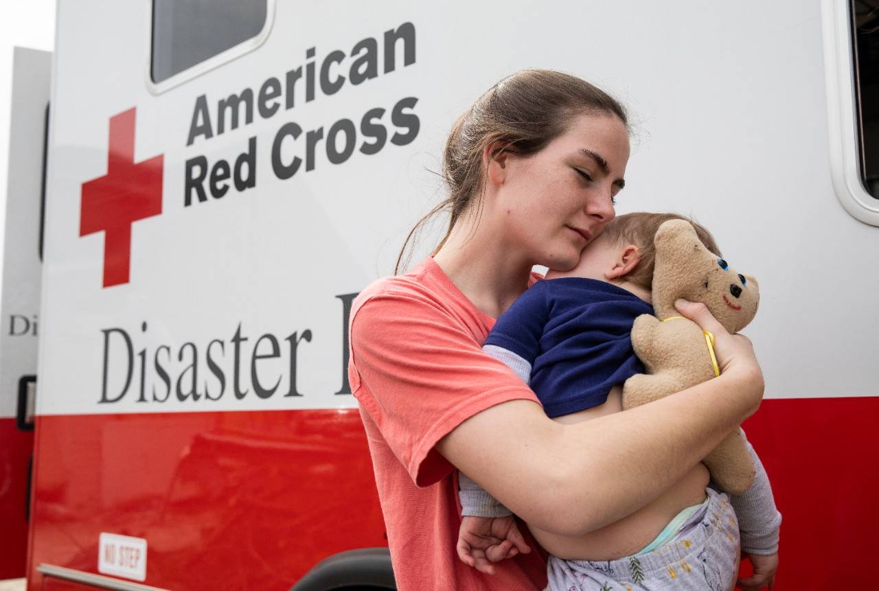 March 5, 2020. Baxter, Tennessee.Kristian snuggles her son, Mason (age 11 months), while she waits for a hot meal from the Red Cross mobile feeding vehicle.Photo by Scott Dalton/American Red Cross