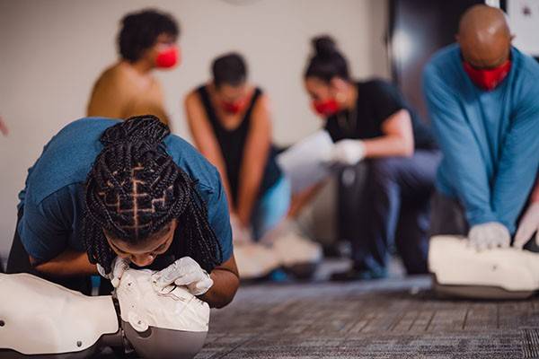 Red Cross volunteers learning CPR with dummies