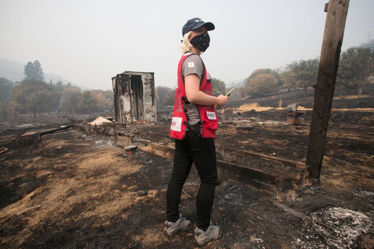 August 24, 2020. Vacaville, California.
LNU Complex Fire burn zone on Pleasants Valley Road in Vacaville, California. Red Cross volunteer Jillian Robertson surveys a property charred by the wildfire.
Photos by Dennis Drenner/American Red Cross