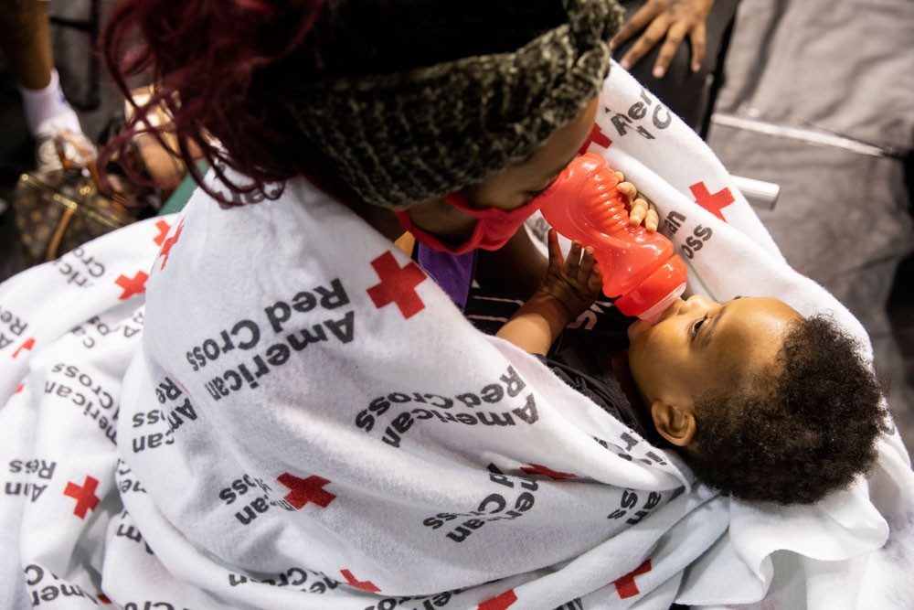 A family stays in a Red Cross shelter during Hurricane Laura