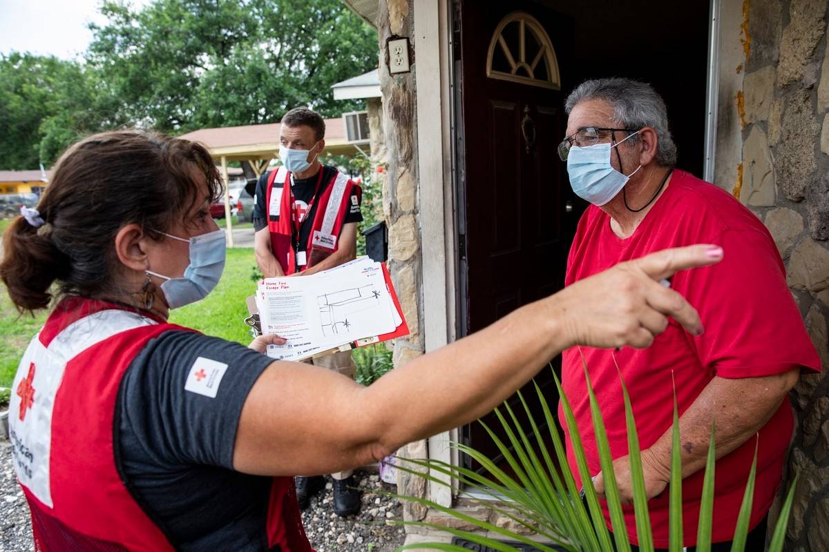 Red Cross Volunteer provides fire safety information to resident