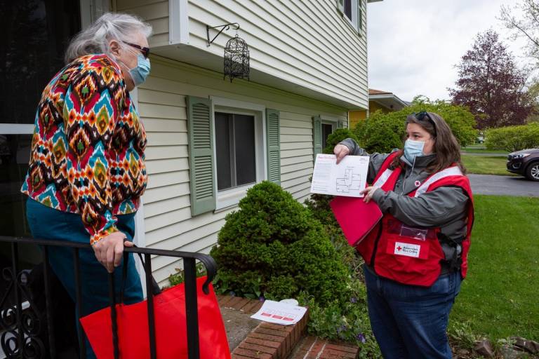 Red Cross volunteer shows resident fire escape plan