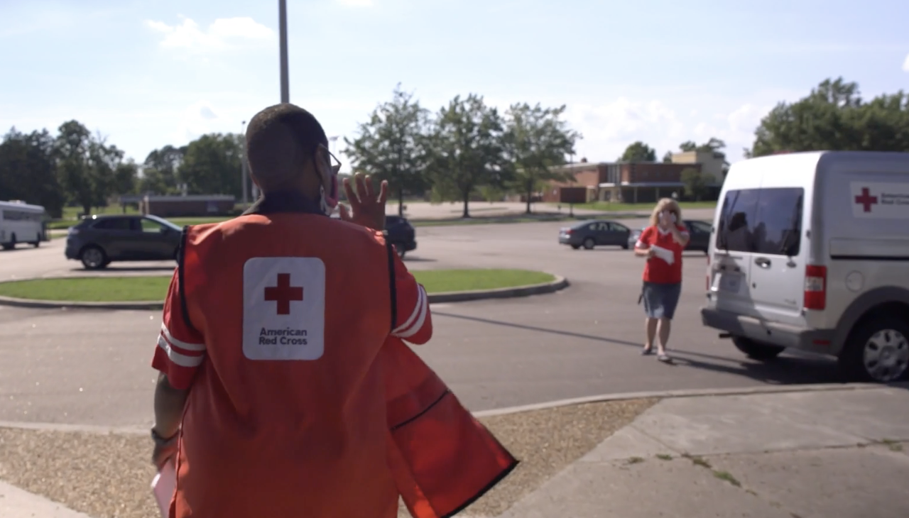 Red Cross volunteer walks near ERV
