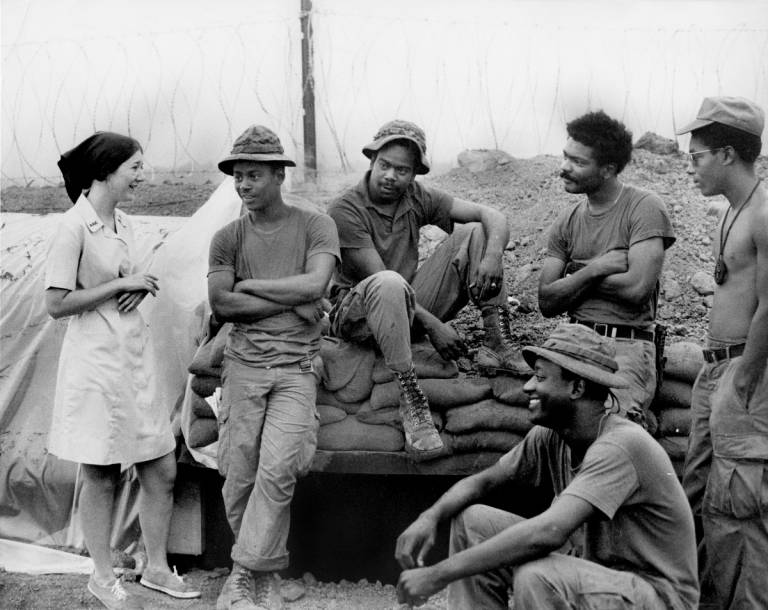 A member of Red Cross staff talks with some of the men of the 3rd Brigade