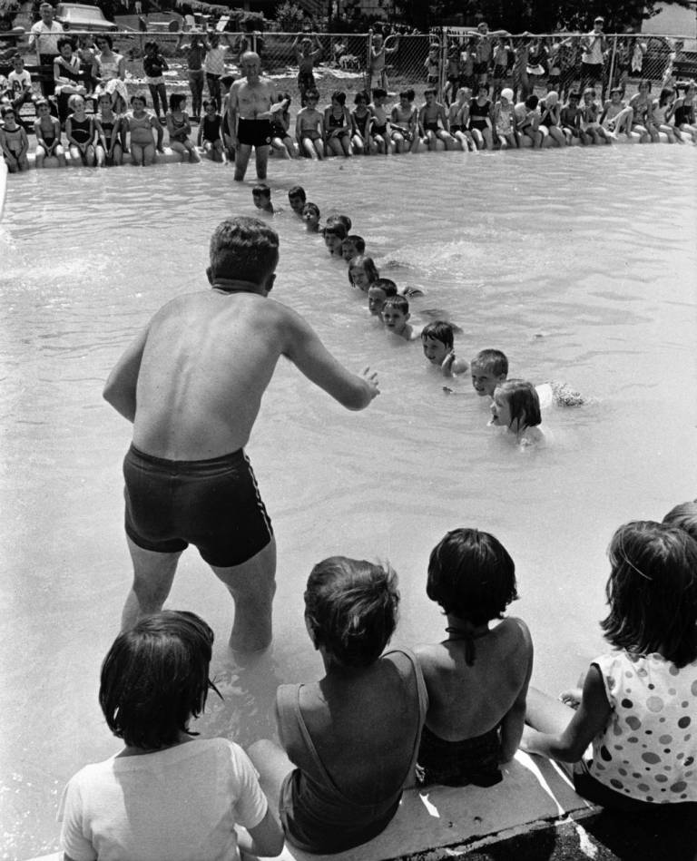 Carl Wesneski, Director of Safety Services, Scranton Chapter, American Red Cross, and son Paul, graduate of Red Cross National Aquatic Instructors School, instruct pre-school youngsters in a prone float.