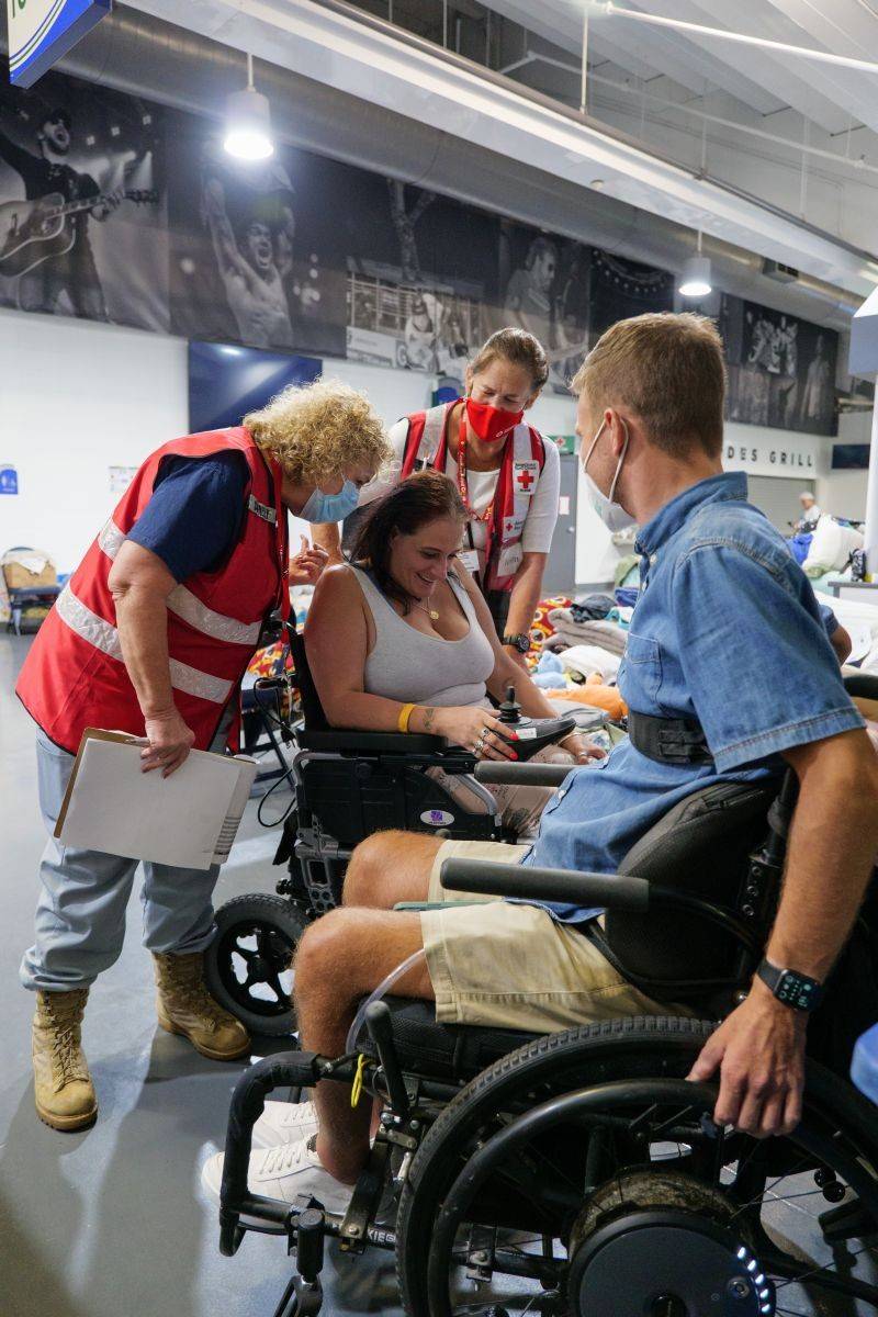 October 10, 2022. Estero, Florida. Meghan Jarosz from Cape Coral, FL is staying in the Red Cross shelter at Hertz Arena along with her teenage daughter. Meghan s wheelchair was lost during the hurricane, so she was using one provided to her at the shelter.  Red Cross nurse, Helen Jacobson learned that Meghan has disabilities that cause increased pain and challenges when using her upper body. Helen was able to reach out to our local Red Cross partner, Center for Independent Living- Gulf Coast (CILGC), an organization that serves individuals with disabilities to get help. CILGC staff provided a powered wheelchair that can be either pushed or powered and once charged, go about 4 miles. Travis Taylor from CILGC delivers the powered wheelchair directly to Meghan at the Red Cross shelter.  This was actually a miraclewhat he did was phenomenal,  said Megan with tears in her eyes. She shared that this would help both her physical and mental health and make a big impact on her family. This is definitely a lifesaver,  Meghan said. Travis gives Meghan a warm smile,  You re more than welcome. I love to be able to help.  Photo by Brad Zerivitz/American Red Cross