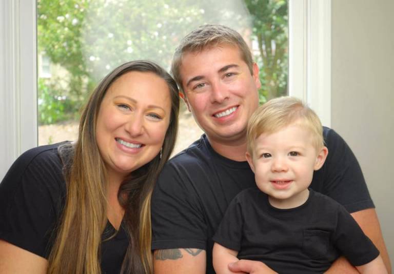 Katie posing with husband John and son Wesley