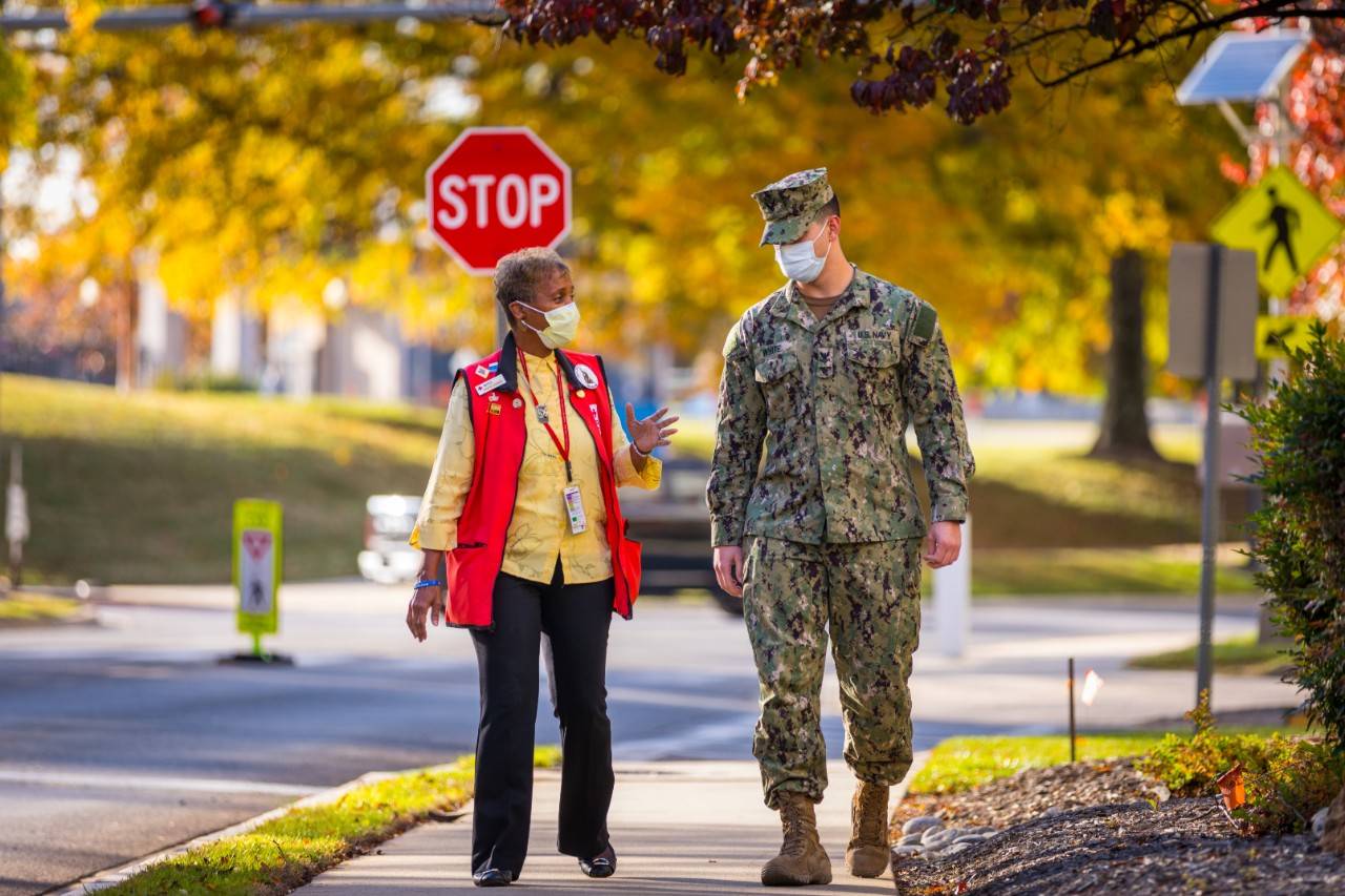 November 16, 2021. Walter Reed National Military Medical Center, Bethesda, Maryland. Red Cross volunteer Janice Chance speaks with a service member at Walter Reed National Military Medical Center in Bethesda, Maryland. 

For more than a century, the American Red Cross has worked alongside service members and their families. 

Today, Red Cross volunteers and employees continue to offer assistance to service members, veterans, families and caregivers through a variety of programs at military and VA hospitals, including rehabilitation therapy, mind-body wellness classes, art therapy, morale-building activities and more. 

Kris Wright, who coordinates Red Cross resiliency programs for patients at Walter Reed says that the Red Cross makes a difference.  The Red Cross fills in the gaps for some things that healthcare systems would love to do but aren't equipped to do,  she said. 

 The Red Cross helps a stay at the hospital feel much more natural. A lot of times people show up here and very intense moments in their lives and we are here to provide comfort,  Wright said.  With our comfort cart or our programs like art therapy, we remind folks that patients are more human. We offer a patient-centered and person-centered element to the care they receive in the hospital,  she said.  Photo by Steve Jeter/American Red Cross

