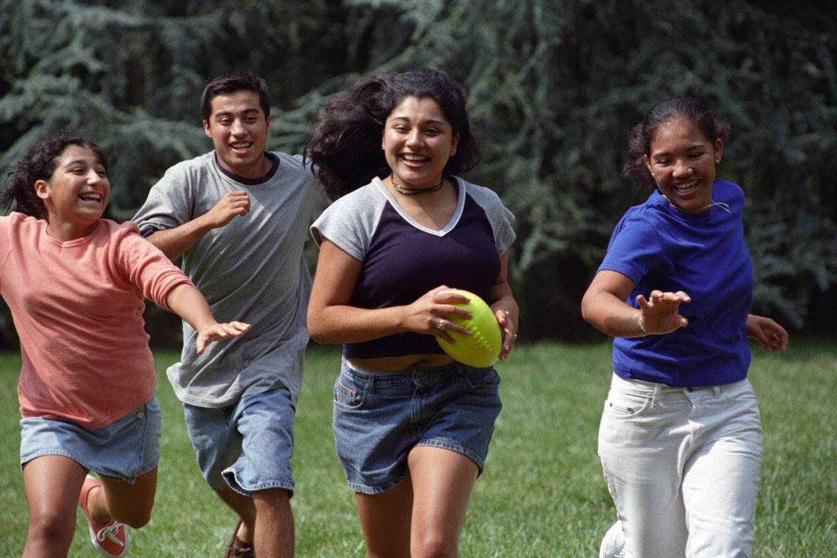 Students running with a ball