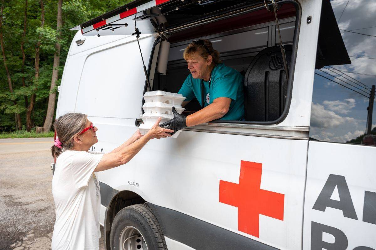Red Cross volunteer delivers a hot meal 