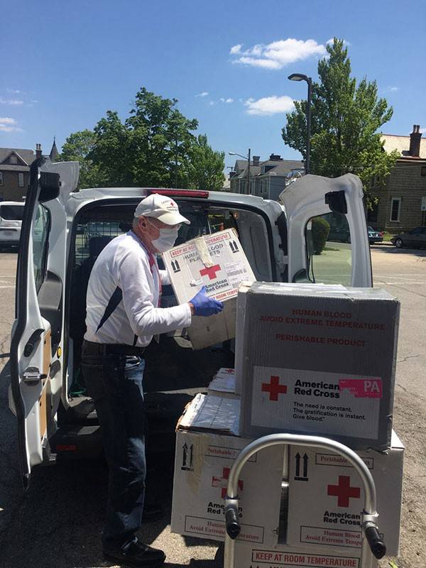 Red Cross volunteer driver, loads blood platelets and other blood products