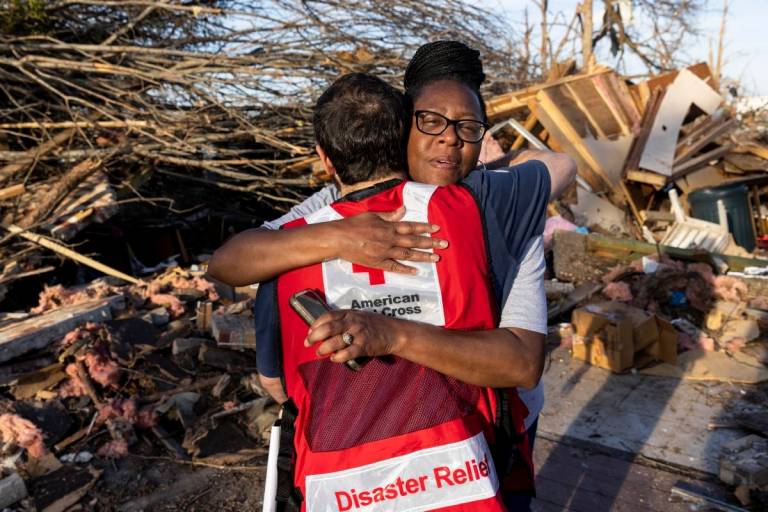 Red Crosser Eric Besson talks with Marcella McGee