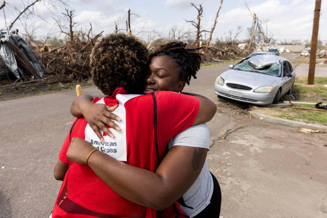 A Red Cross volunteer helping a disaster victim