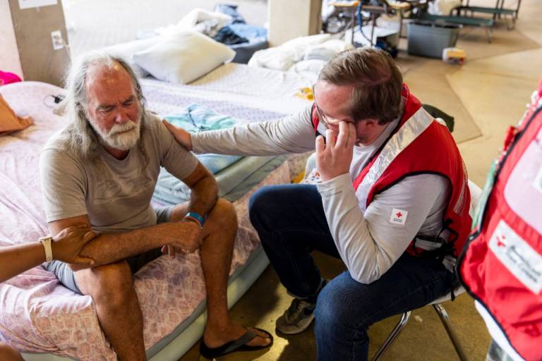 Edwin Heilscher chokes up while talking to American Red Cross staff member Doyle Rader