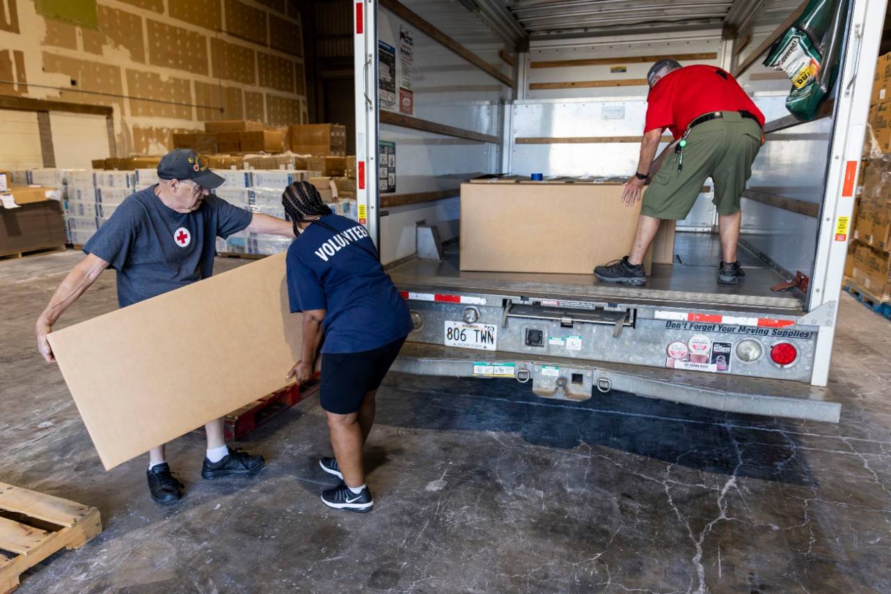 August 15, 2023. Wailuku, Hawaii.
American Red Cross volunteers Terry Buchen, Ellen White and Paul Hicks load a truck full of blankets at the Red Cross warehouse in Wailuku on Maui. The blankets will be delivered and distributed to individuals and families staying at the War Memorial Gymnasium in the War Memorial Stadium Complex in Wailuku, where the Red Cross and its partners operate the largest shelter on the island.
Photo by Scott Dalton/American Red Cross
