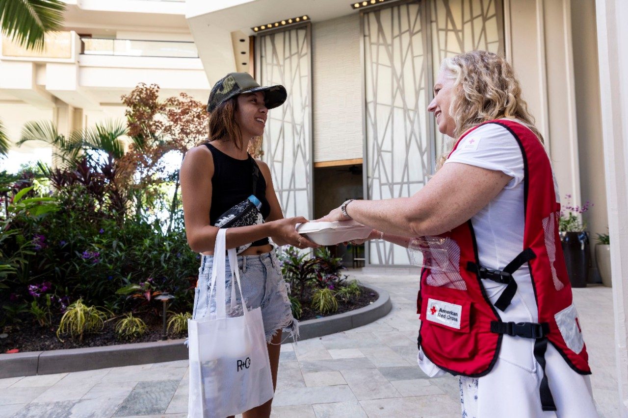 disaster relief volunteer walking with youth resident