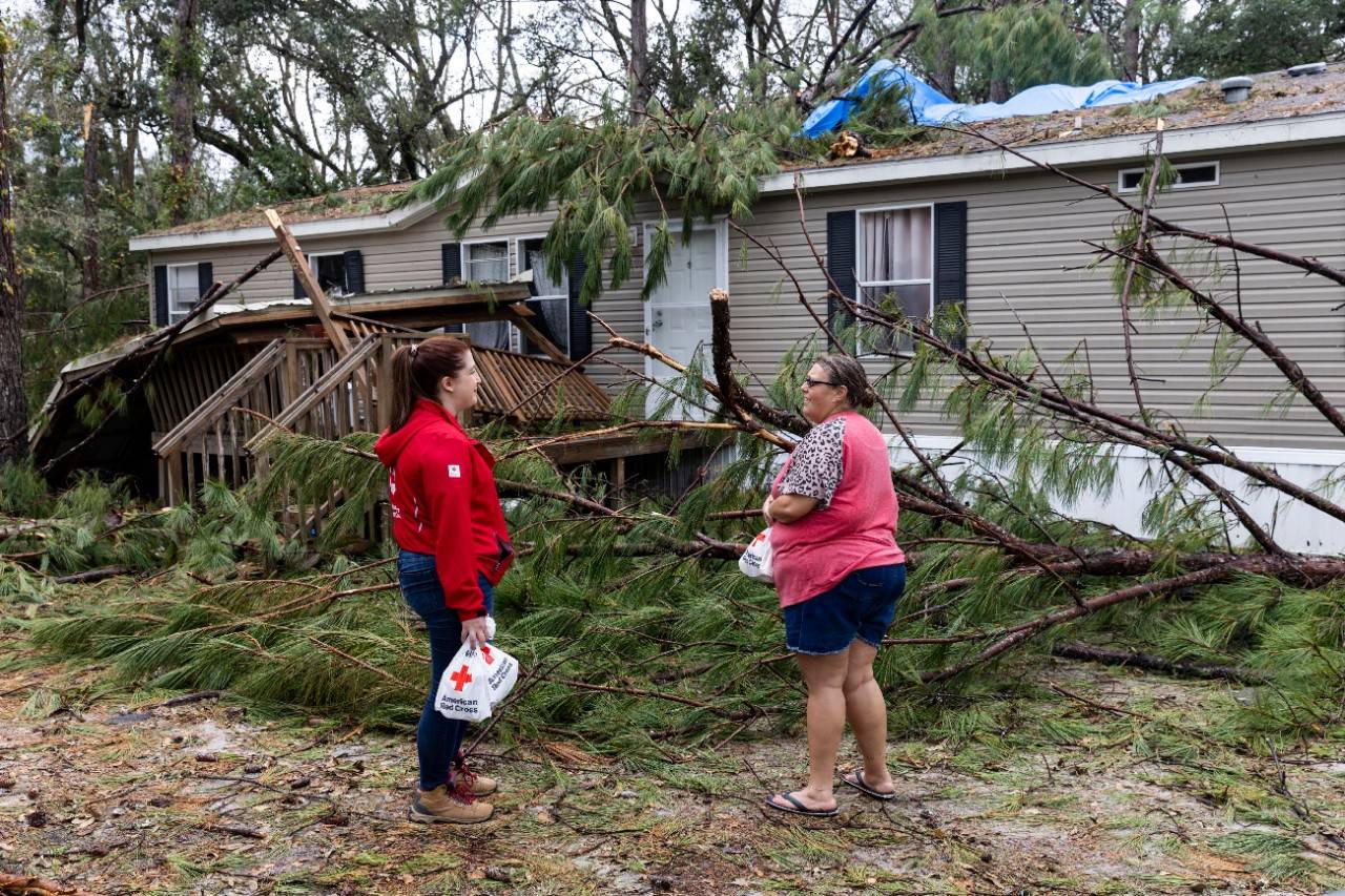 September 2, 2023. Valdosta, Georgia.
The Summerlin s evacuated to the home of another family member as part of a plan to safely ride out Hurricane Idalia. That s where they found themselves huddled beneath a mattress as the hurricane force winds shook the home for what felt like an endless amount of time. As Idalia finally passed and they walked outside seeing trees strewn about the yard, they couldn t believe they had survived the experience.  

Then Lindsay Summerlin returned to her own home of a dozen years and found several large trees had crashed through it. The Valdosta, Georgia, resident had never experienced a hurricane before.  That s why it is so devastating. I ve seen it on TV, but I ve never been in it myself. It misses us every time. We have been so lucky, until now.  Due to the climate crisis, hurricanes are becoming more intense and destructive.

The family is temporarily living in a travel trailer in their backyard as they wait to begin the massive clean-up efforts.  I keep thinking about what am I going to with all of this stuff, and I think I m going to have to let a lot of these things go.  

Red Cross disaster workers provided comfort kits with toiletries, snacks and water to help the family to stay comfortable. While she suffered a great loss, she is thankful for the resources and support of the Red Cross volunteers who have helped her along the way.

The Summerlin s have spent Labor Day weekend with their extended family removing debris, gathering supplies and securing tarps to prevent more rainwater from causing further damage. As they walked along the home, it began to rain again.
Photo by Scott Dalton/American Red Cross