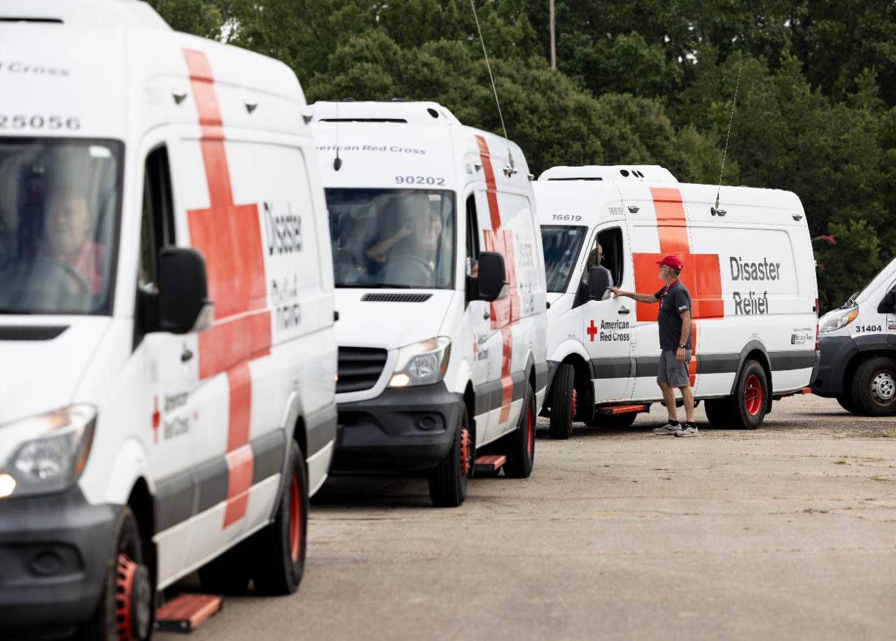 September 3, 2023. Tallahassee, Florida.
Red Cross disaster responder, Pete Basiliere, speaks with Mathew Michels as emergency response vehicles wait to be loaded with supplies in Tallahassee, Florida. Once his vehicle is packed with much-needed meals, water, comfort kits and cleaning supplies, he will start circulating through neighborhoods impacted by Hurricane Idalia. Volunteers like Pete and Mathew are essential to delivering support after disasters. This is especially true now as hurricanes are becoming more intense and destructive with higher rainfall and storm surges due to the climate crisis.
Photo by Scott Dalton/American Red Cross