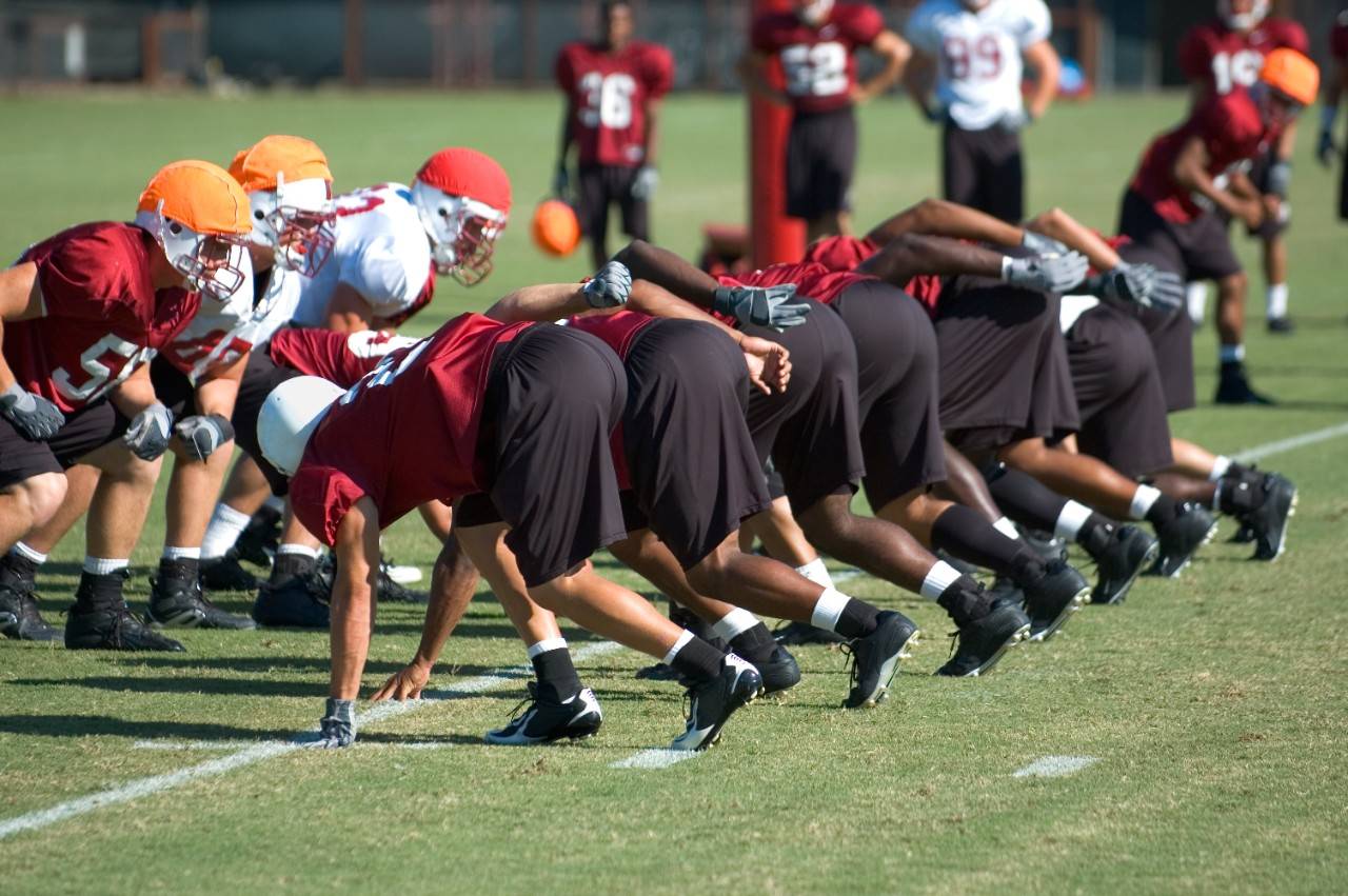 The team lines up for the snap at football practice.Other football shots:
