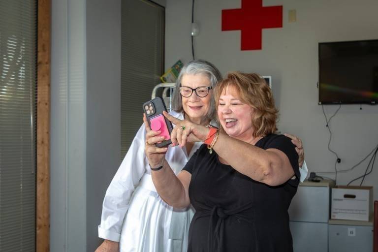 Kate Forbes taking a selfie with an American Red Cross volunteer