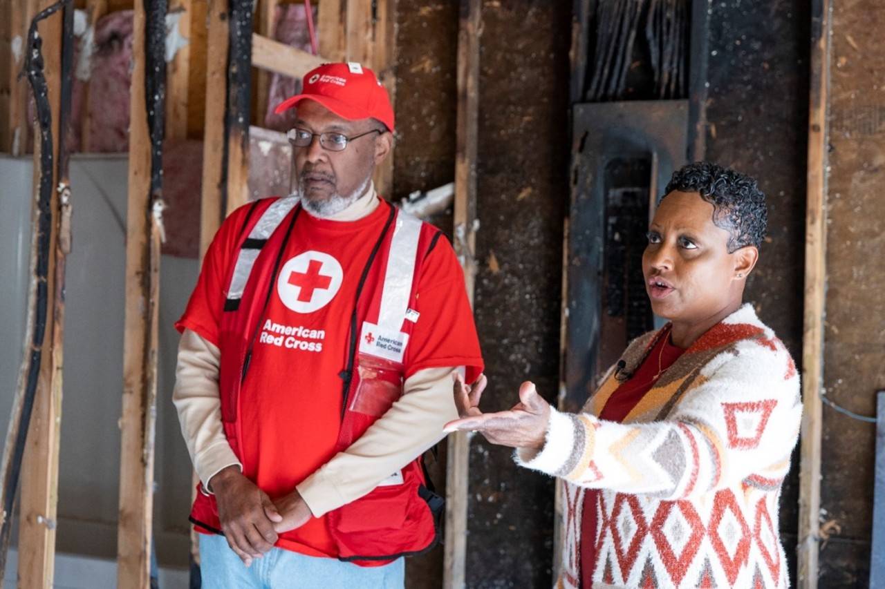 A Red Cross volunteer asses the damage after a fire