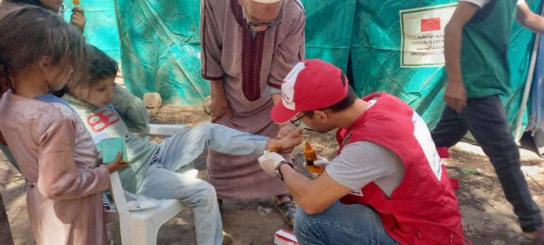 Red Crescent volunteer helping