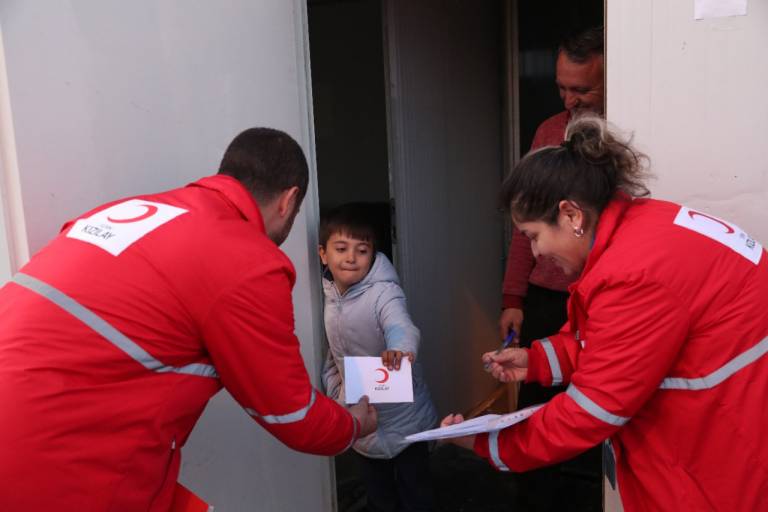Turkish Red Crescent help a family with cash assistance