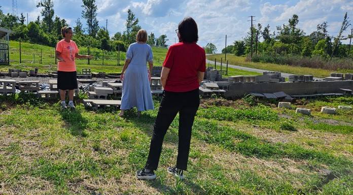 Clara Rice (at left) went through terrible losses when tornadoes destroyed her Kentucky home twice in just three years. Here she walks her property with Red Cross representatives.