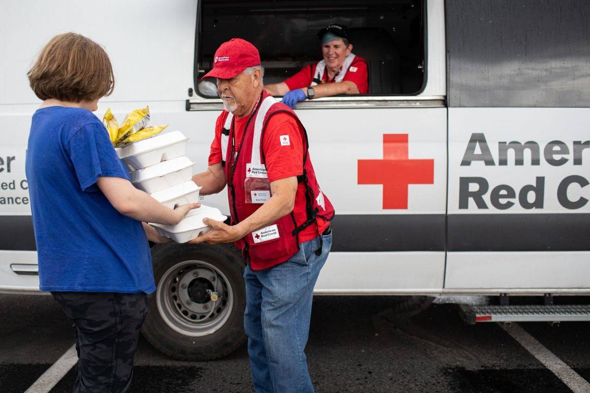 June 26, 2024. Ruidoso, New Mexico.
Residents of Ruidoso, N.M. begin to return to a village scarred by two fast moving, deadly wildfires in June 2024. American Red Cross volunteers Cristobal Herrera and Karen Hoover share lunch with one resident. The Red Cross continued to provide meals, sheltering and other essentials to residents in this new phase of disaster relief for the community.
Photo by Marko Kokic/American Red Cross