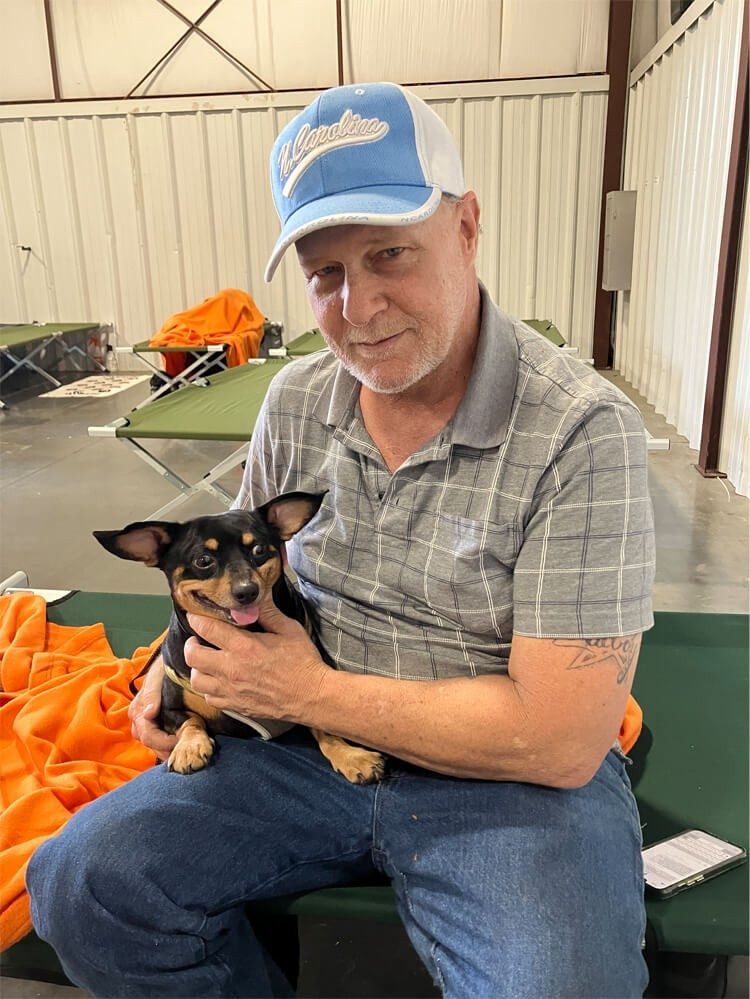 Scott Bradburn pictured with his dog in a shelter.