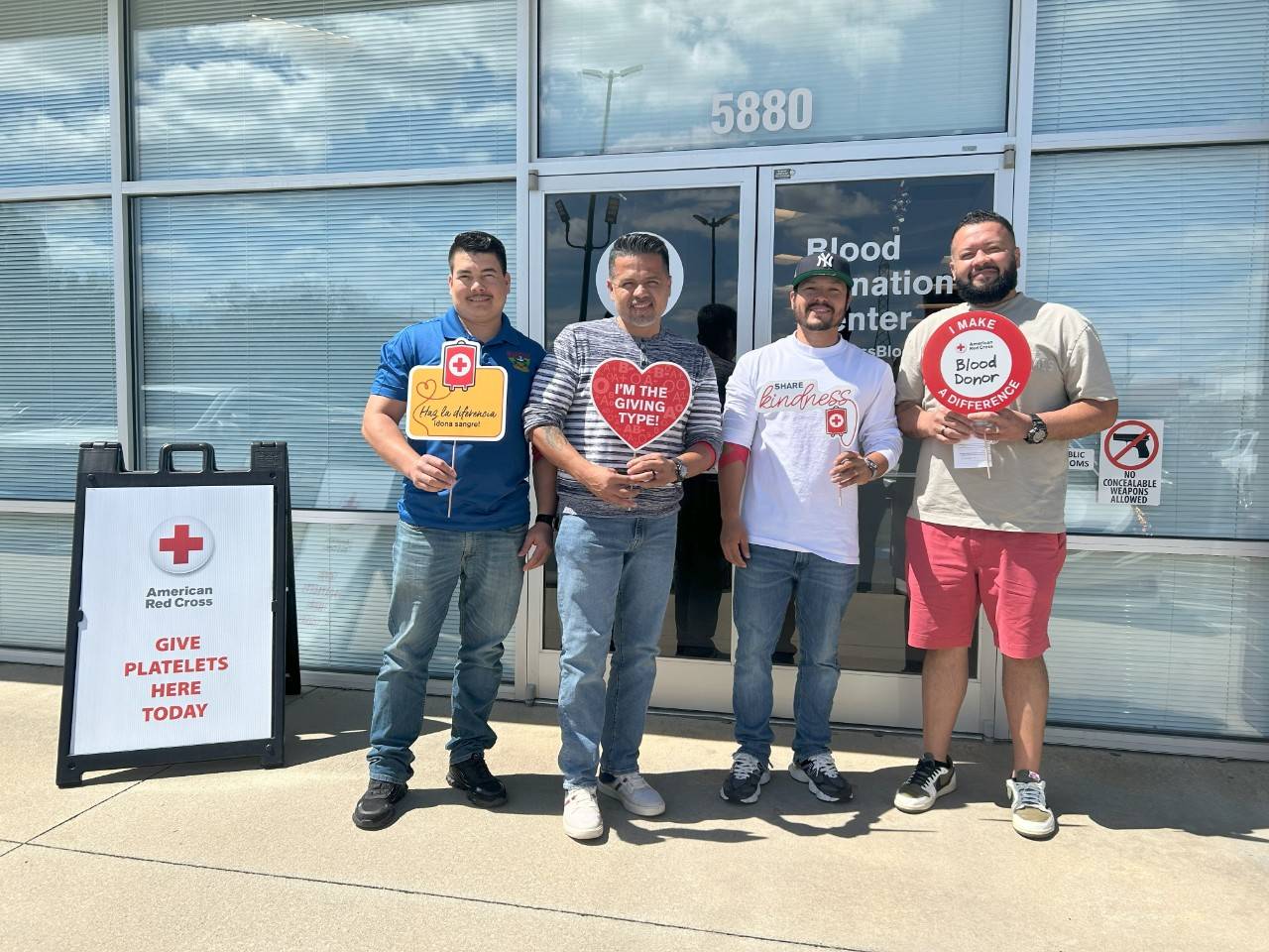 Photo of the Rodriguez brothers standing in front of a Red Cross Blood Donor Center.