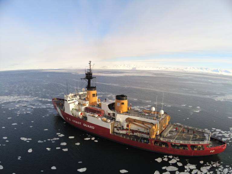A large vessel is shown in the icy waters of Antarctica.