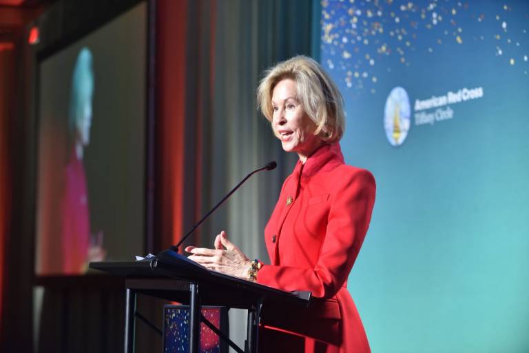 woman stands at a podium
